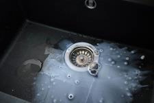 Clogged kitchen sink with slow-draining water