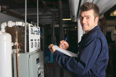 Technician inspecting a modern home furnace system